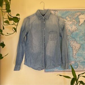 Uniqlo light wash button up blue denim shirt with a pocket